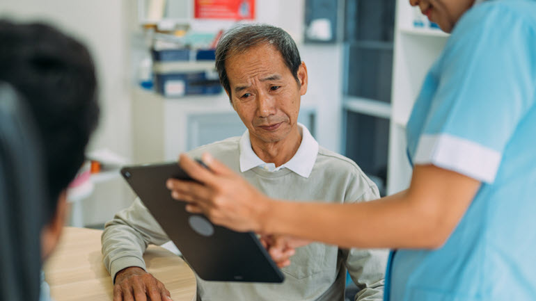 Medic explaining information to a patient in another language